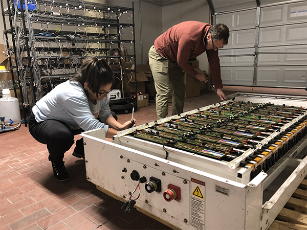 Katrina Ramirez-Meyers and Jay Whitacre disassembling battery pack.