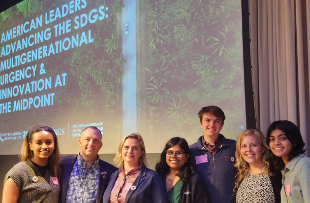 CMU Students and Alex at meeting  standing in front of presentation  slides