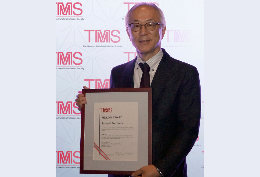 Tadashi Furuhara holding award