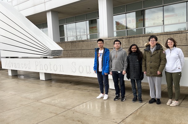 Dr. Krause and 4 students standing in front of Advanced Photon Lab